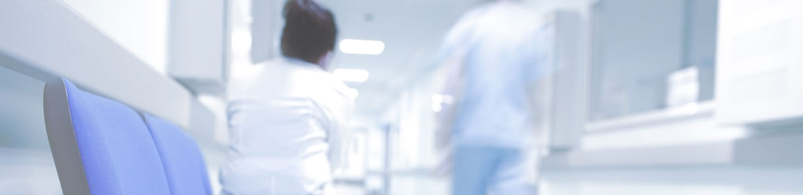 doctor and nurse in blurry hospital hallway
