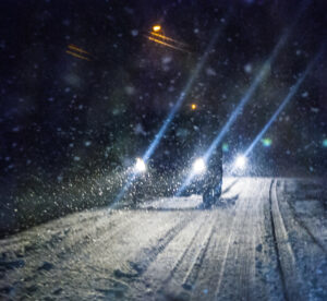 car driving in a snow storm
